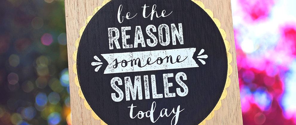 sign that says be the reason someone smiles today